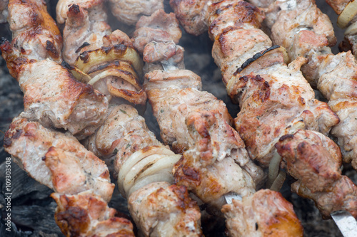 Kebabs on skewers cooked on the coals in the smoke