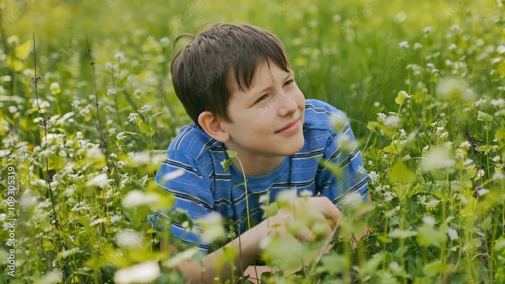 boy teenager outdoors lying on green grass white flowers landscape nature boy teenager outdoors lying on green grass white flowers landscape nature