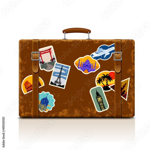Vintage brown threadbare suitcase with retro stickers Fototapeta