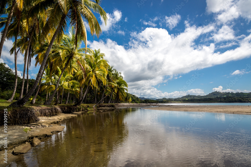 Beautiful blue sky day with a blue sea and empty sand. Playa Samara, Costa Rica, Central America.