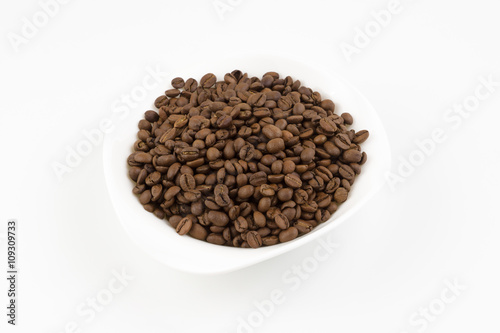 white plate full of coffee beans