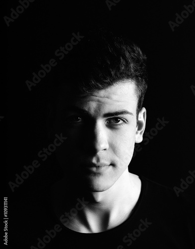 half-face young man portrait in low-key

