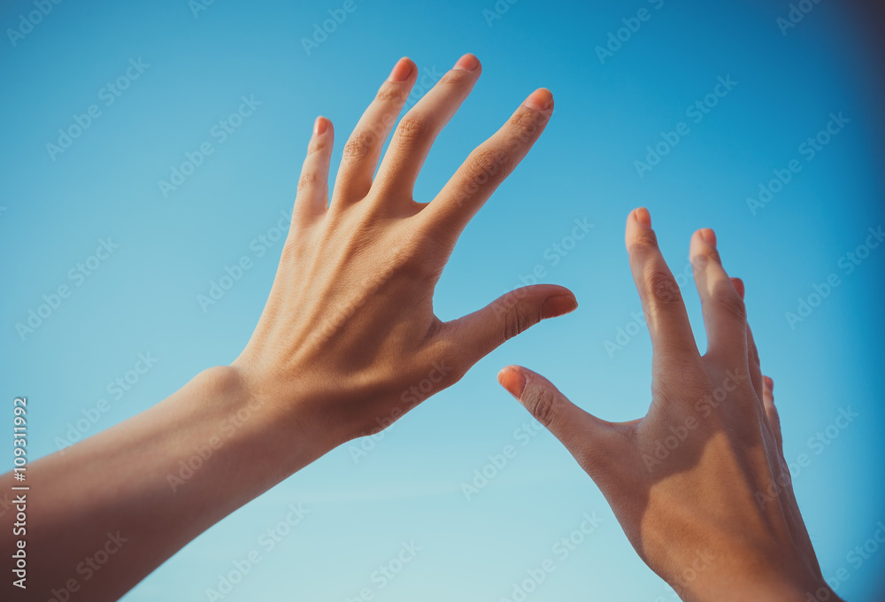 Two hands against the sky Two hands against the sky