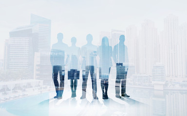 business people silhouettes over city background