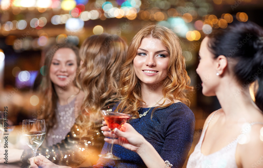 happy women with drinks at night club happy women with drinks at night club