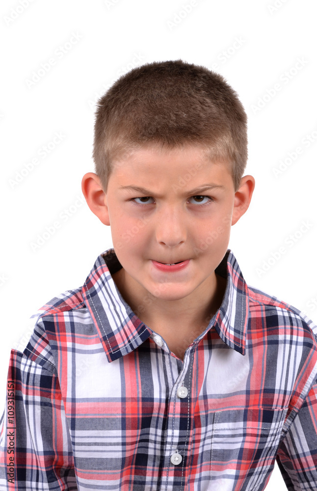 young boy making a mean face isolated on white background young boy making a mean face isolated on white background