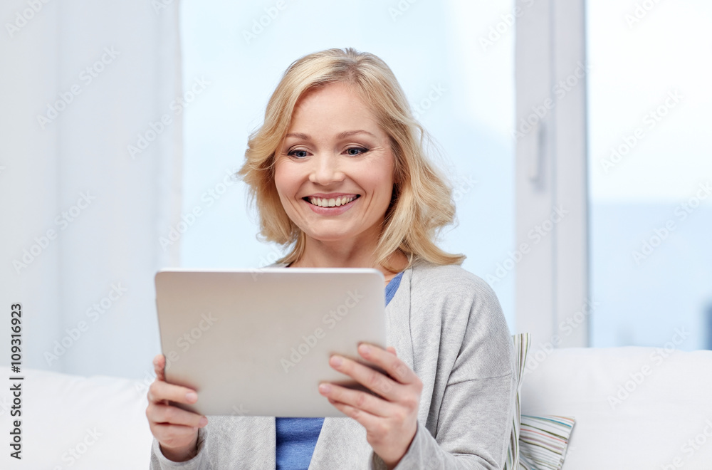 happy middle aged woman with tablet pc at home happy middle aged woman with tablet pc at home