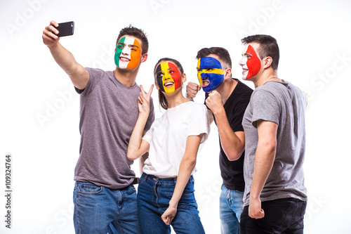 Group of football fans support their national team: Belgium, Italy, Republic of Ireland, Sweden take selfie photo on white background. European football fans concept.