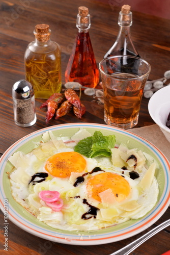 Dish with fried eggs boundary and aromas