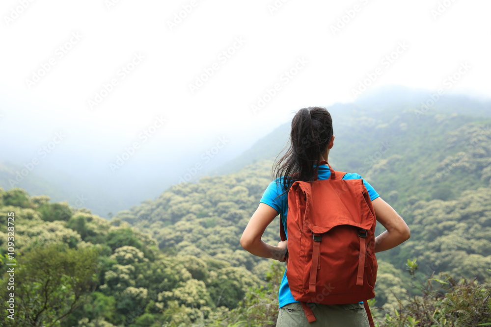 young woman hiker enjoy the view on mountain peak young woman hiker enjoy the view on mountain peak