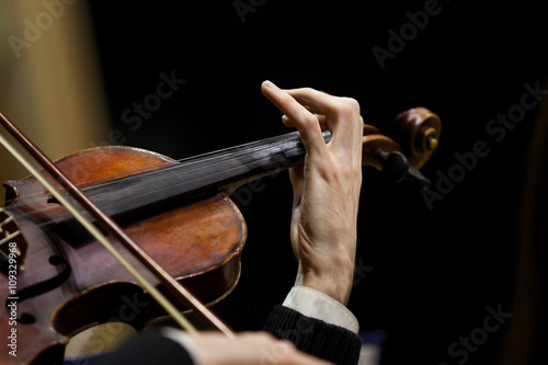 Hands musician playing the violin closeup