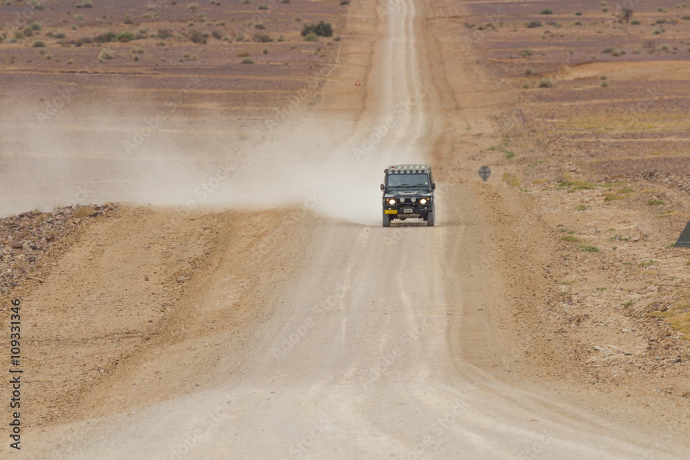 SUV in the scenic road C12 to Fish River Canyon, Namibia SUV in the scenic road C12 to Fish River Canyon, Namibia