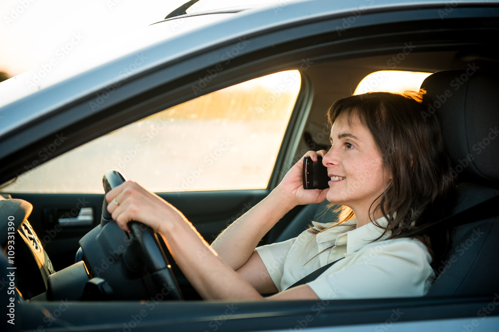 Woman driving car on phone