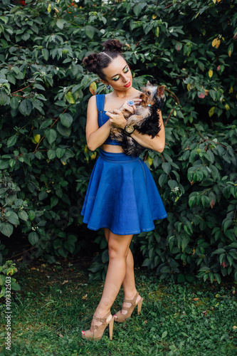 Young beautiful woman with Yorkshire Terrier