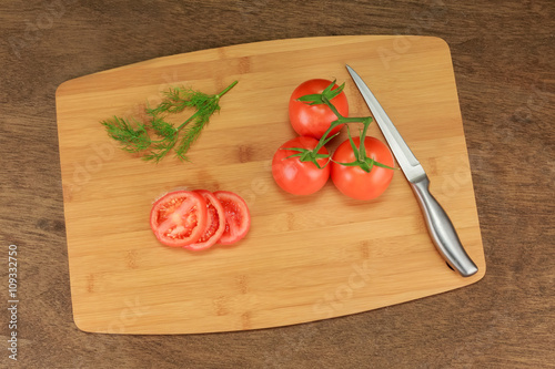 tomato dill with herbs for the preservation on old wooden table.