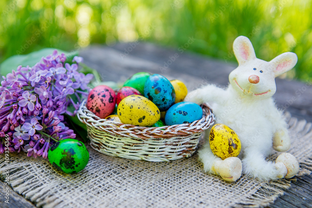 painted Easter eggs with bunny on grass background painted Easter eggs with bunny on grass background