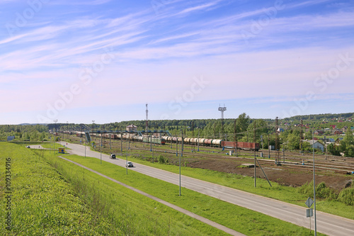 Freight trains with tanks stand on railway station © singulyarra