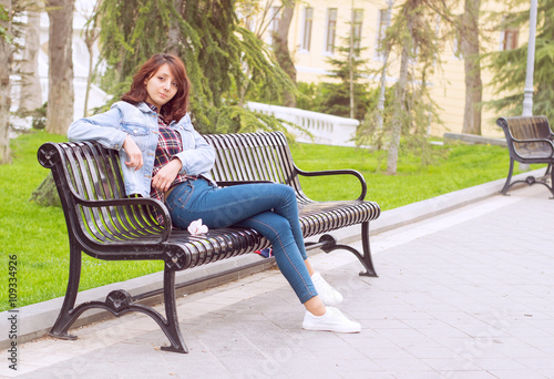beautiful woman sitting on a bench