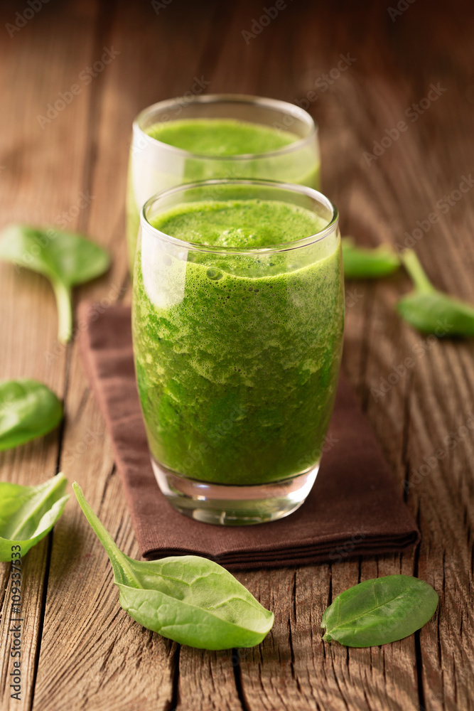 Fototapeta premium Fresh healthy green spinach smoothie with ingredients on rustic wooden background, selective focus