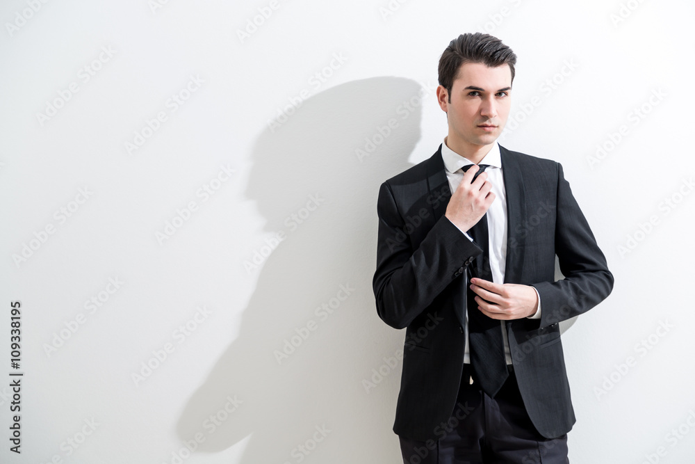 Businessman adjusting tie Businessman adjusting tie