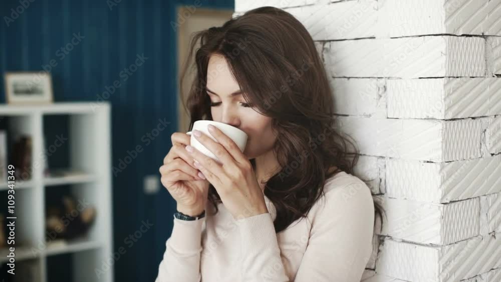 Happy girl drinking coffee and relaxing in cafe, smiling and looking at camera. Happy girl drinking coffee and relaxing in cafe, smiling and looking at camera.