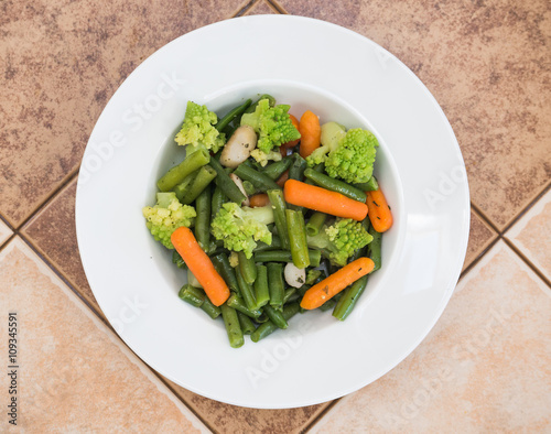 Salad with romanesco broccoli, carrot, mushroom, green beans  in white plate