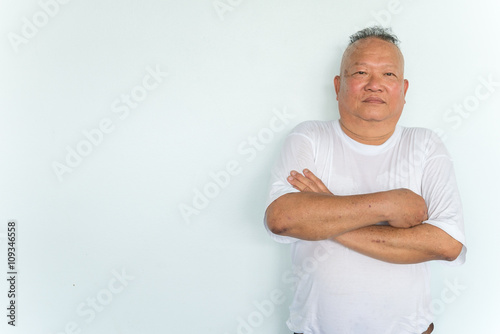 Fotografia Happy 60 year old senior asian man ; fold one's arms across the chest standing i