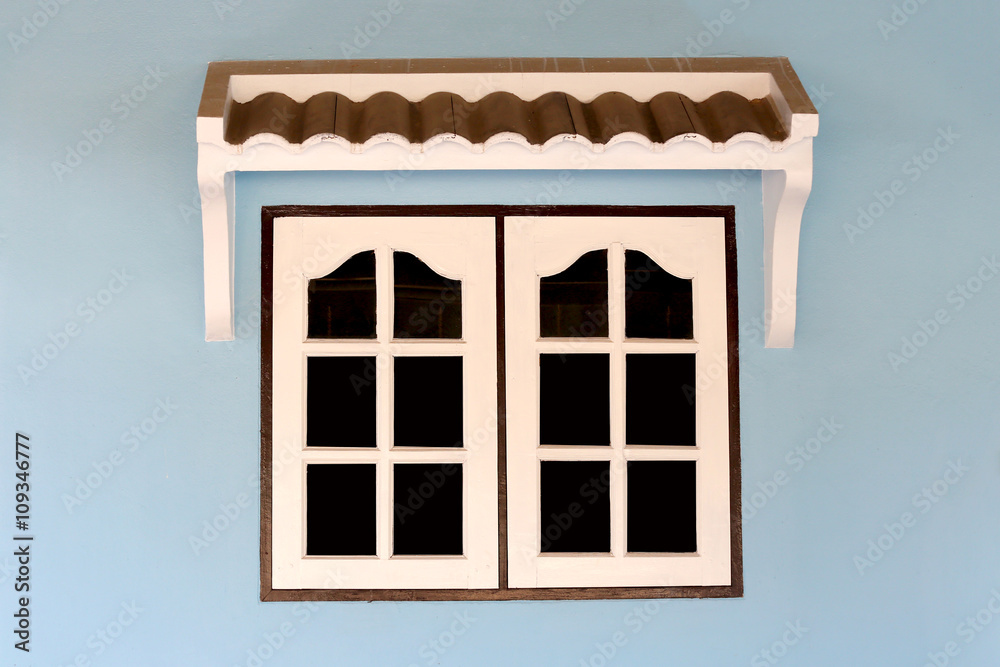 Fototapeta premium windows of house on blue wall.