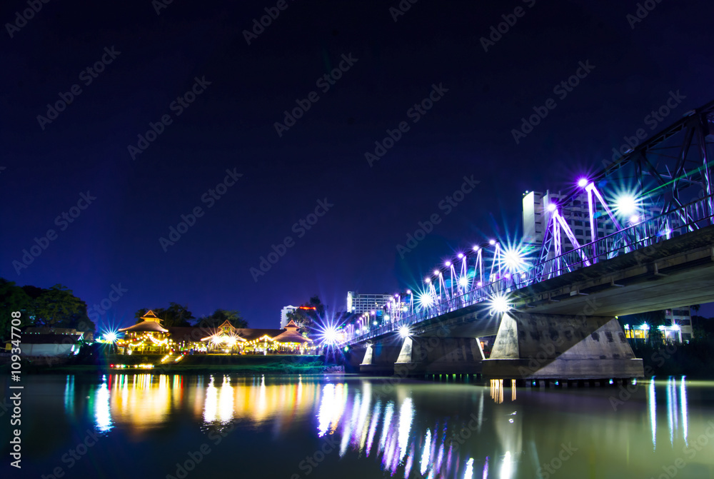 Iron bridge At night Chiangmai in Thailand , With Lens Flare