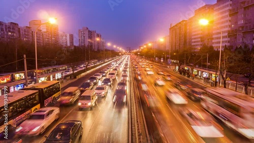 The bird's view of the busy second ring road traffic and buildings in Beijing, China. Slow motion
