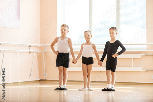 Young boys and a girl with posing at ballet dancing class