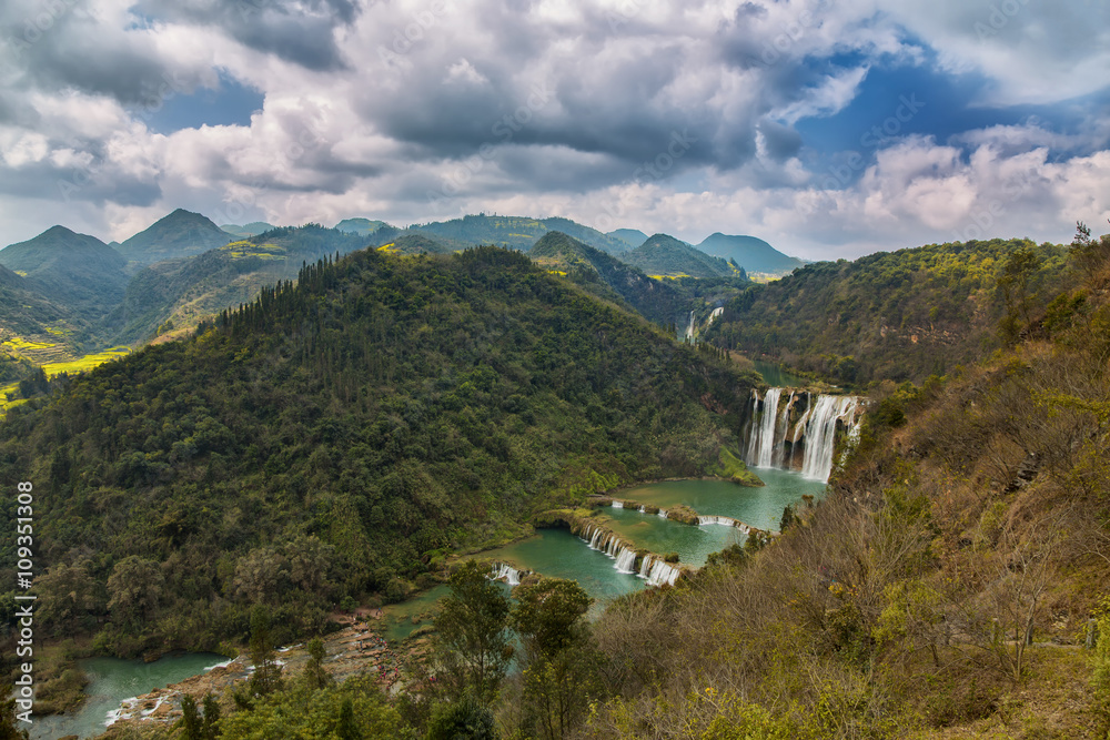 Landscape of Yunnan with waterfall and mountains in forest