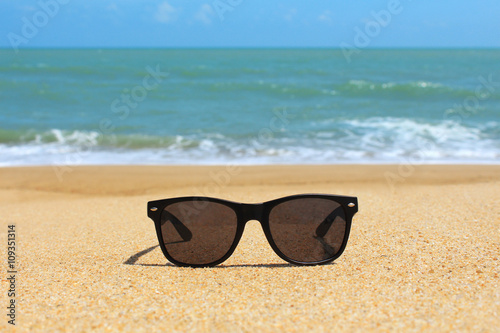 Black sunglasses on the beach
