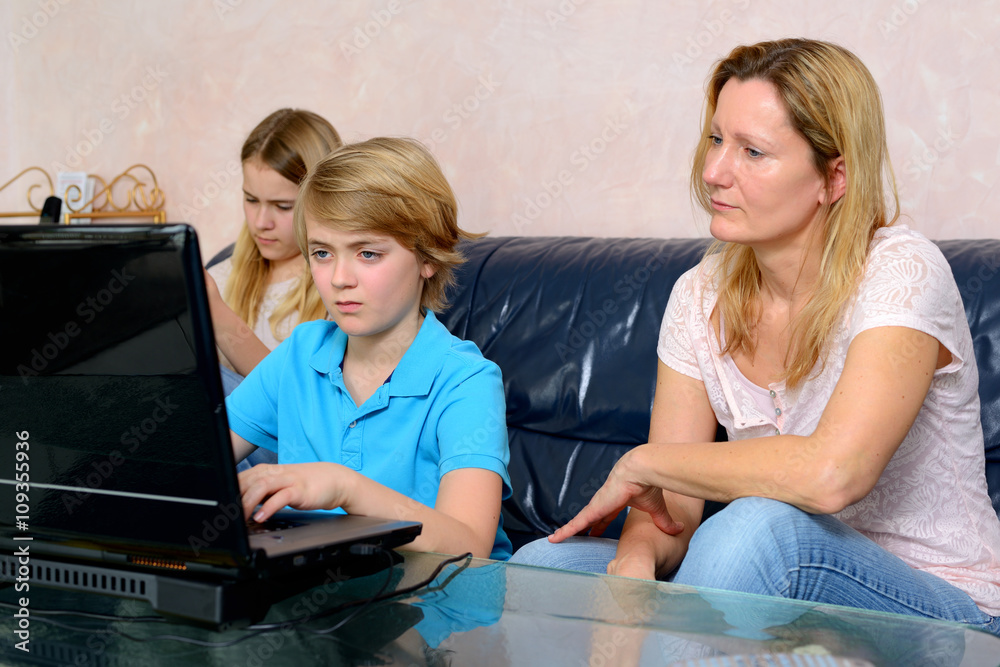 mother and her children using computer mother and her children using computer