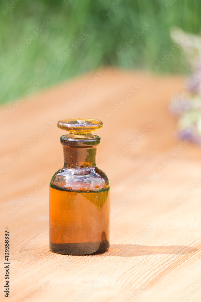 little brown bottle on booden board and grass little brown bottle on booden board and grass