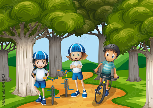 Three kids riding bike in the park