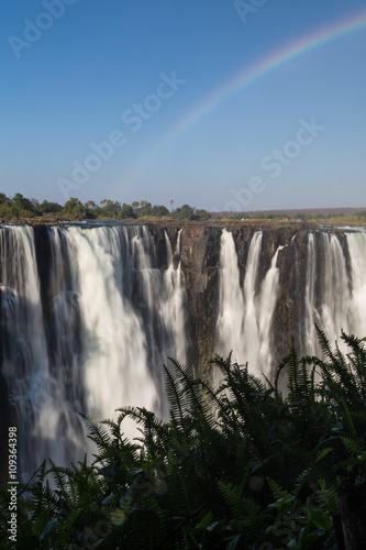 Victoria Falls in October with rainbow crossing