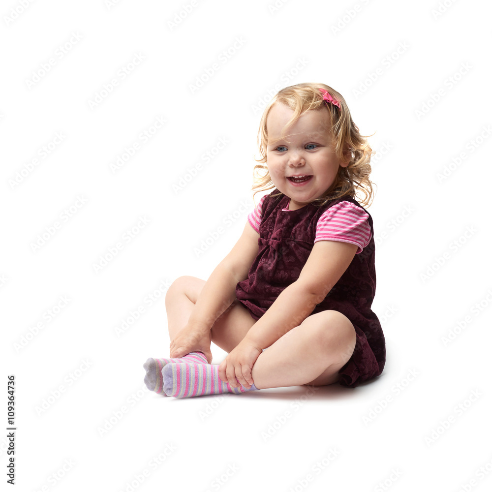 Young little girl sitting over isolated white background Young little girl sitting over isolated white background