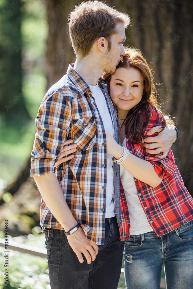 Fototapeta premium Lovely couple standing on the street and kissing