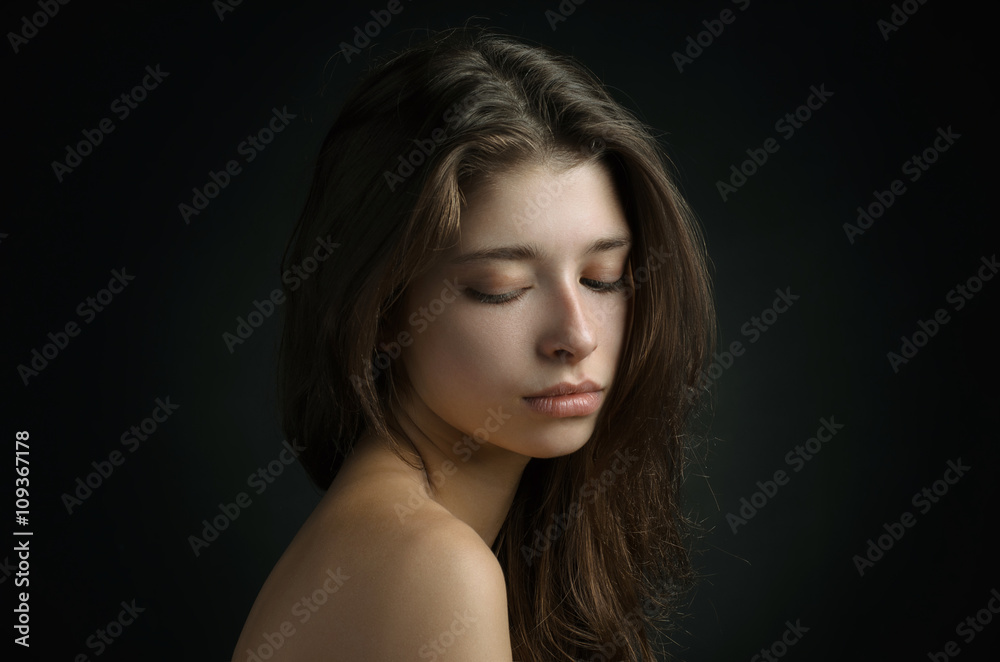 Dramatic portrait of a girl theme: portrait of a beautiful girl on a background in the studio Dramatic portrait of a girl theme: portrait of a beautiful girl on a background in the studio