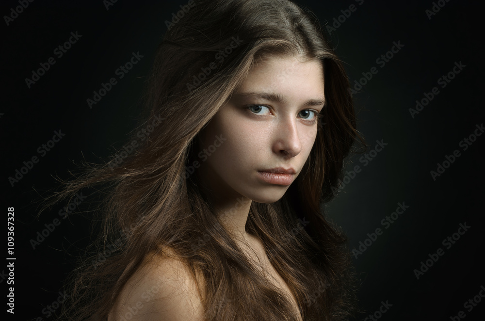 Dramatic portrait of a girl theme: portrait of a beautiful girl on a background in the studio Dramatic portrait of a girl theme: portrait of a beautiful girl on a background in the studio