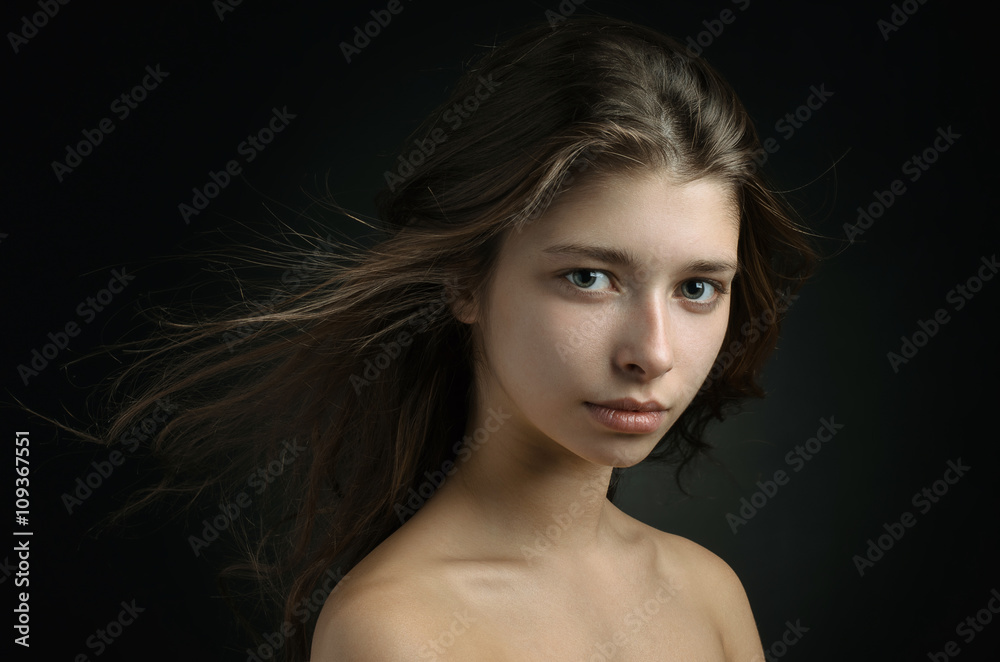 Dramatic portrait of a girl theme: portrait of a beautiful girl on a background in the studio Dramatic portrait of a girl theme: portrait of a beautiful girl on a background in the studio