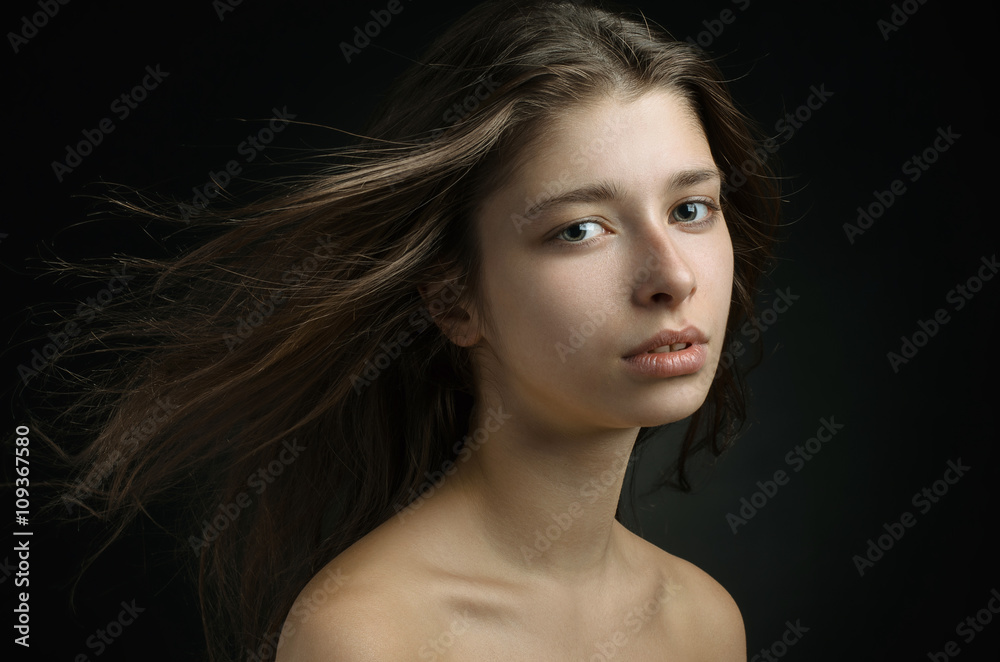 Dramatic portrait of a girl theme: portrait of a beautiful girl on a background in the studio Dramatic portrait of a girl theme: portrait of a beautiful girl on a background in the studio