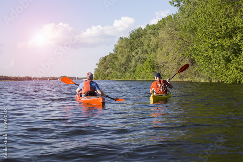 Travel on the river in a kayak on a sunny day.