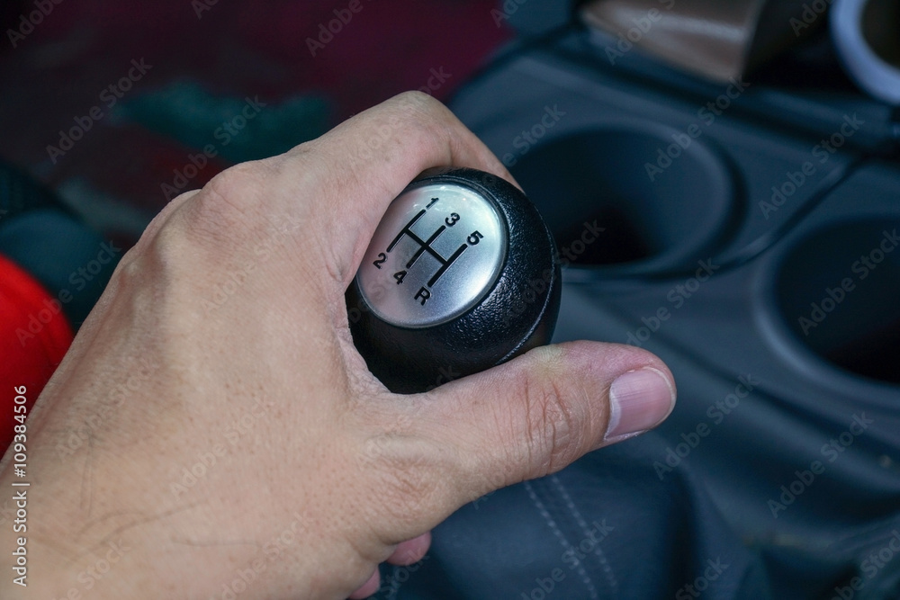 Fototapeta premium Left hand holding a gear shift lever
