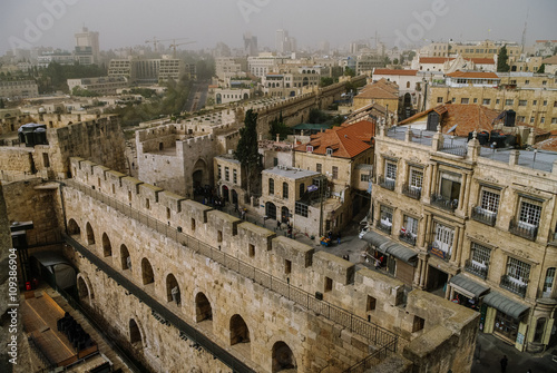 Walls and castle of old city. Jerusalem panoramic roof view in time of sand storm. Israel