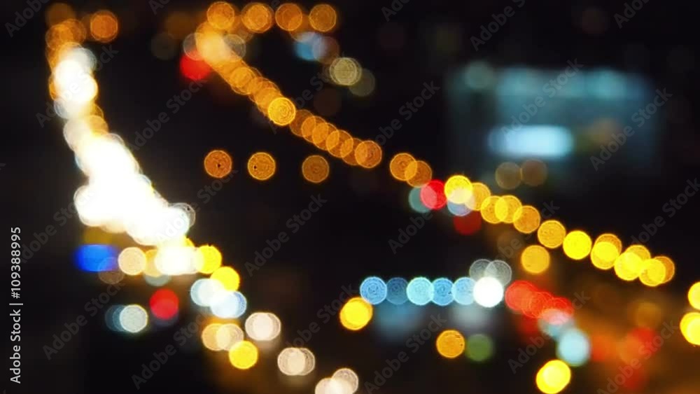 Night city street traffic colorful bokeh lights in motion