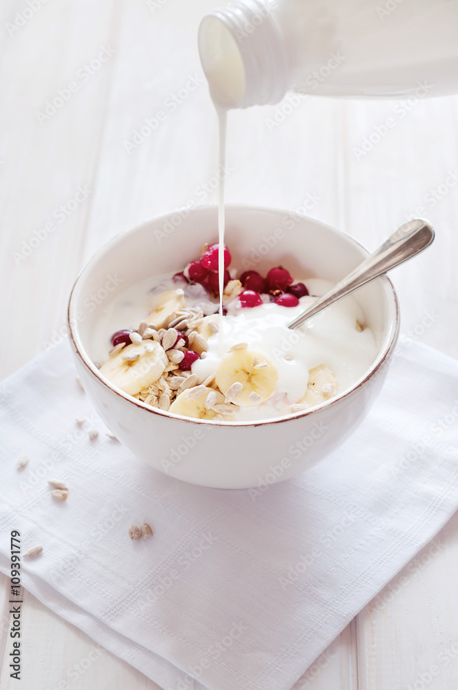Healthy breakfast. Oatmeal with bananas, cranberries and sunflow Healthy breakfast. Oatmeal with bananas, cranberries and sunflow