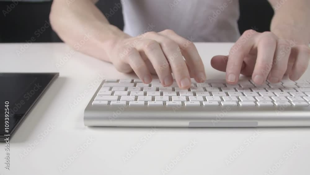 camera panning along the keyboard and tablet when a man typing on the keyboard and use the tablet camera panning along the keyboard and tablet when a man typing on the keyboard and use the tablet