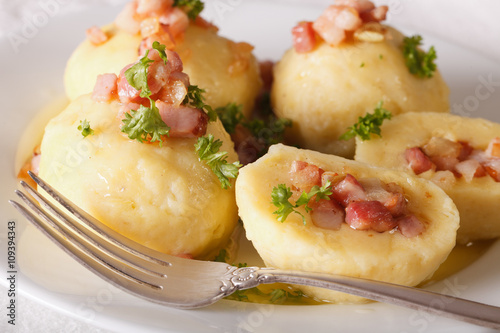 Potato dumplings stuffed with ham, bacon and onion close-up. horizontal 